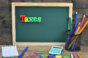 Taxes spelled out on chalkboard (7/2020)