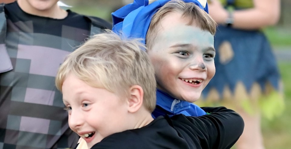 Students in costume hugging (10/2023)
