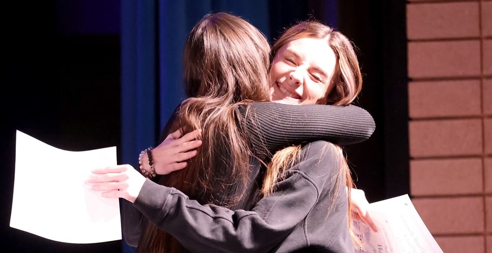 Faculty and student hug (2/2025)