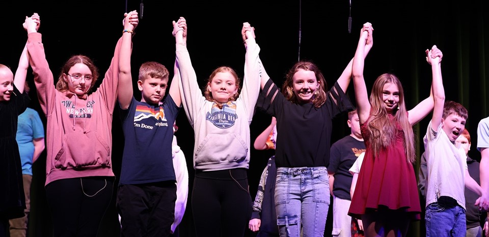 Students celebrate on stage (3/2025)