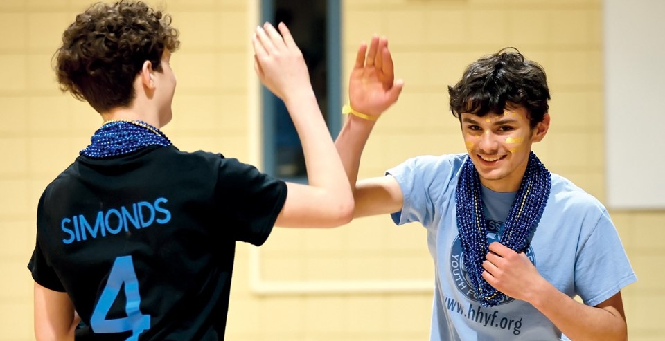 Two boys high-fiving (4/2025)